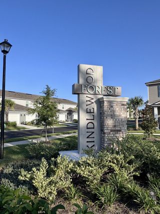 Street view A welcoming entrance in Kindlewood Forest by D.R. Horton, showcasing lush landscaping in Middleburg, FL.