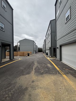 Street view Modern gray townhomes with clean lines in Ira Ave Lofts by Center City, San Antonio, TX.
