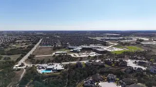 Community Amenities Expansive aerial view of Deerbrooke Cottages by Chesmar Homes, showcasing a vibrant Leander, TX community.