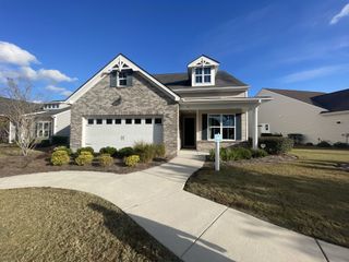 Charming brick home with landscaped yard in Four Seasons at Lakes of Cane Bay by K. Hovnanian® Homes (Summerville, SC).