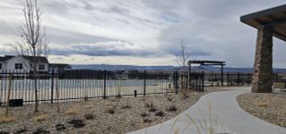 A serene community pool area with scenic mountain views in Montaine by Brightland Homes (Castle Rock, CO).