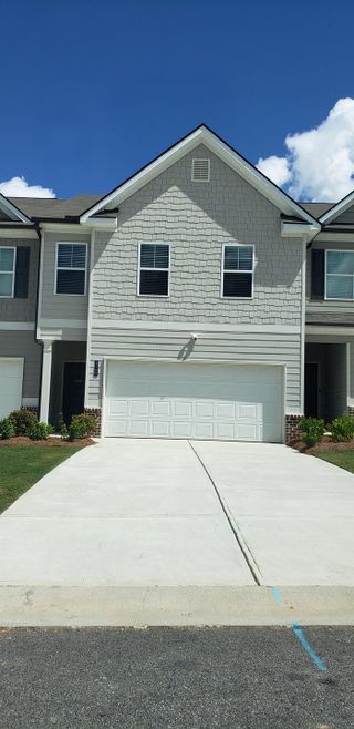 Street view A charming grey townhouse with a two-car garage in Sandtown Falls by Rockhaven Homes, Atlanta, GA.
