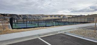 Modern tennis courts and scenic hillside homes in Montaine by Brightland Homes (Castle Rock, CO).