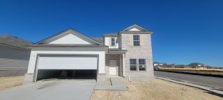 A modern two-story home with brick facade in Paloma Park by M/I Homes, San Antonio, TX. Spacious garage and clean lines.