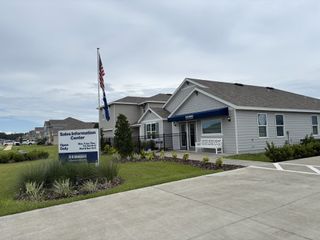 A welcoming sales center with landscaped surroundings in Avalon Woods by D.R. Horton (Newberry, FL).