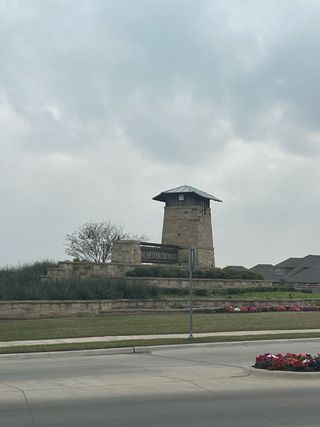 Street view A charming stone entrance tower greets visitors to Winchester Crossing by D.R. Horton in Princeton, TX.