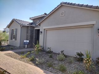 A charming home with a modern exterior and desert landscaping in Blossom Rock by Pulte Homes (Apache Junction, AZ).