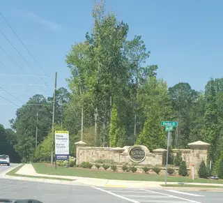 Entrance to Butner Estates by D.R. Horton in South Fulton, GA, featuring a stone sign and lush greenery.