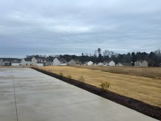 Street view A serene neighborhood view in The Meadows at Oxford by LGI Homes, showcasing spacious plots and modern homes (Oxford, NC).