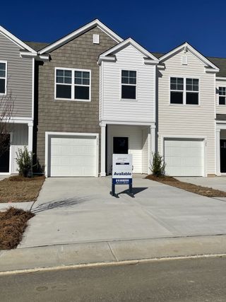 A modern townhouse with a clean facade in Carolina Groves by D.R. Horton, located in Moncks Corner, SC.