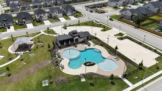 Aerial view of a community pool and park in Cascades at Onion Creek by M/I Homes, showcasing modern amenities in Austin, TX.