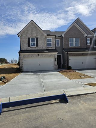 Elegant brick townhouse with modern features in Towns at Ivy Creek by Lennar (Buford, GA).