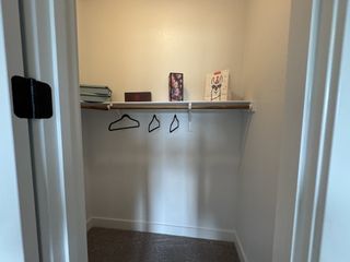 A spacious walk-in closet with wooden shelving and ample storage.