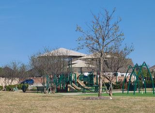 Street view A charming playground with sunshades in Star Trail 76' by Britton Homes, Prosper, TX.