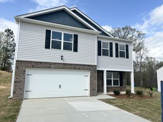 A modern two-story home with a brick facade and clean lines in Barwell Park by D.R. Horton (Raleigh, NC).