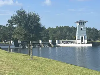 Community Amenities A scenic view with a charming blue tower and water feature in RiverTown - Bluffs by Mattamy Homes (St. Johns, FL).