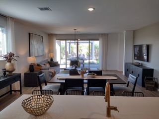 Model Home A modern open-concept living space featuring chic decor, natural lighting, and a seamless flow to the outdoor patio.