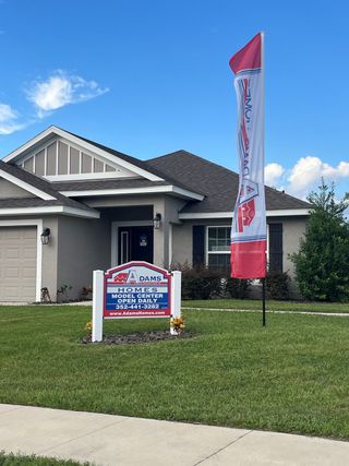 Charming gray home with a manicured yard in Oak Hill Plantation by Adams Homes, Ocala, FL.