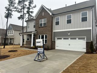 A modern two-story home with brick and gray siding in The Manors at Haywood Glen by D.R. Horton (Knightdale, NC).