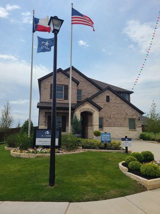 A charming brick home with manicured landscaping in Forest Park by M/I Homes (Princeton, TX).
