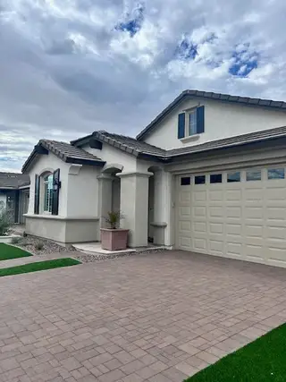 A charming home with elegant arches and a paved driveway in Ridgeline at Acclaim by Fulton Homes (Avondale, AZ).