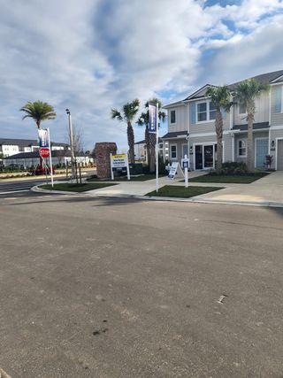 A charming townhouse with palm trees and modern design in The Landing by D.R. Horton (Middleburg, FL).
