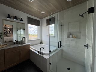 A chic bathroom features a glass shower, elegant tub, and stylish vanity with wooden accents and modern fixtures.
