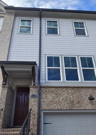 Street view A modern brick and shingle townhouse with elegant finishes in West Village by Peachtree Residential (Smyrna, GA).