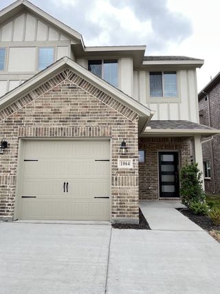 A charming brick and stucco home with modern accents in Elevon by Pacesetter Homes (Lavon, TX).