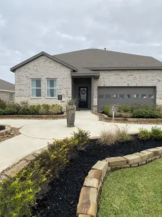 A beautiful modern brick home with a landscaped front yard in Anniston: Avante Collection by Lennar (Katy, TX).