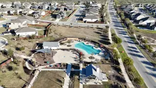 Community Amenities An aerial view of the Homestead community featuring a pool and playground by Coventry Homes in Schertz, TX.
