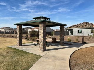 A picturesque park pavilion in El Cidro by Pulte Homes, set against charming homes in sunny Goodyear, AZ.