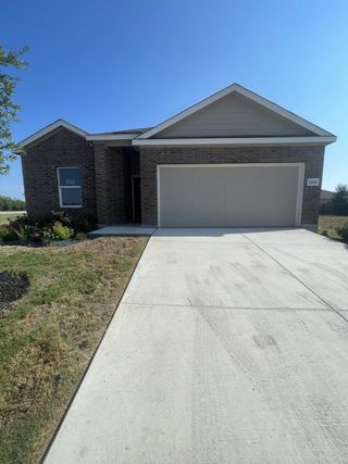 A modern single-story home with clean landscaping and a spacious driveway in Waterwheel by Lennar (San Antonio, TX).