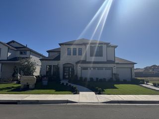 A beautiful stone façade home with a manicured lawn in Santa Rita Ranch by CastleRock Communities (Liberty Hill, TX).