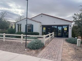 A charming single-story home with a tiled roof and landscaped front in Heartland Ranch by KB Home (Coolidge, AZ).