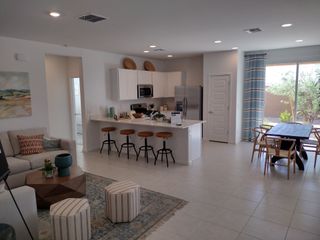 A modern open-concept living area with a sleek kitchen island, cozy seating, and a spacious dining space.