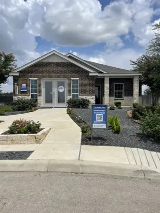 A charming brick and stone home with a landscaped front yard in Mission del Lago by Lennar (San Antonio, TX).