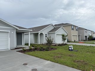 A charming modern home with a well-kept lawn in Avalon Woods by D.R. Horton in Newberry, FL.