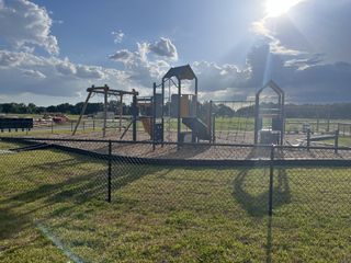 A vibrant playground basking in sunlight within Millwood Estates - The Meadows by Lennar, Ocala, FL.