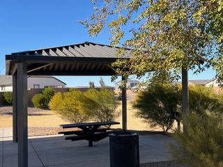 Community Amenities A charming park pavilion with a picnic table and lush greenery in Tortosa by D.R. Horton (Maricopa, AZ).
