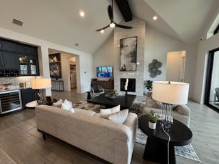 A spacious living room with modern decor, sleek furnishings, and a cozy fireplace, featuring a blend of style and comfort.