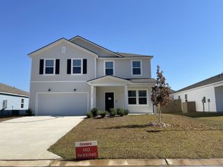 A charming white two-story home with black shutters in Bradford Pointe by Centex, Summerville, SC.