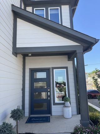 Charming modern entrance with sleek gray accents in Sarah's Creek by Taylor Morrison (Pflugerville, TX).