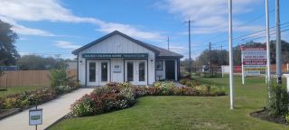 A charming welcome center with vibrant landscaping at Hidden Oasis by Lennar in San Antonio, TX.