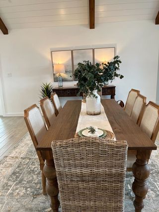 A charming dining room with a rustic wooden table, upholstered chairs, and elegant decor, creating a warm, inviting atmosphere.