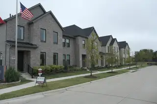 Modern brick townhomes in Painted Tree - Village District by CB JENI Homes, McKinney, TX. Clean design and landscaped paths.
