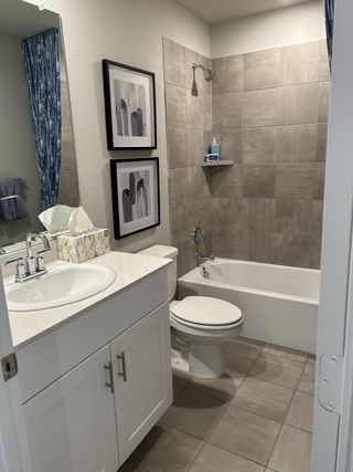 A sleek bathroom with neutral-toned tiles, modern fixtures, and stylish decor for a functional and inviting space.