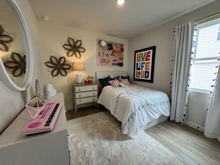 A playful bedroom with colorful decor, vibrant wall art, and a cozy single bed, perfect for a child's imaginative space.
