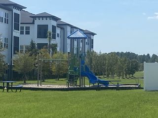 Modern apartments with nearby playground in The Landing by D.R. Horton, offering family-friendly amenities (Middleburg, FL).