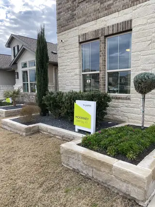 Charming stone facade home with lush landscaping in Homestead at Old Settlers Park by Tri Pointe Homes (Round Rock, TX).